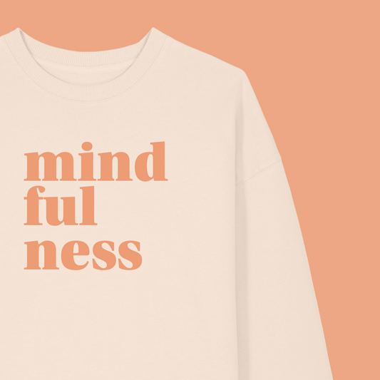 Beige sweatshirt with 'mindfulness' text on a peach background, featuring the brand 'MABEL'.