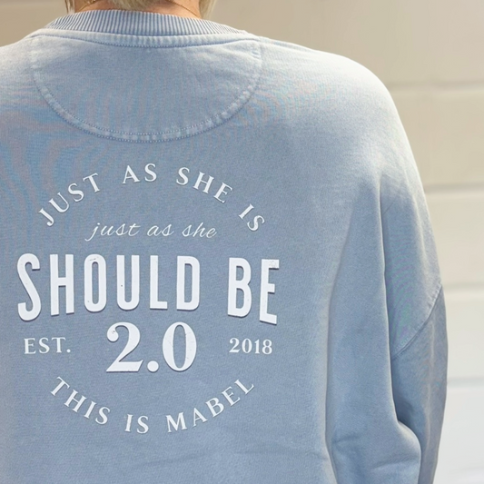 Light blue sweatshirt with text on the back, featuring the brand 'This is Mabel'.