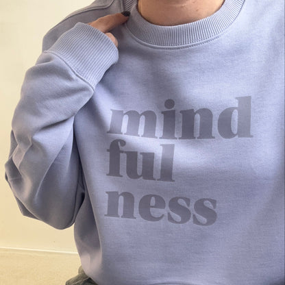 Violet oversized this is mabel sweatshirt with 'mindfulness' text worn by a person on a light background
