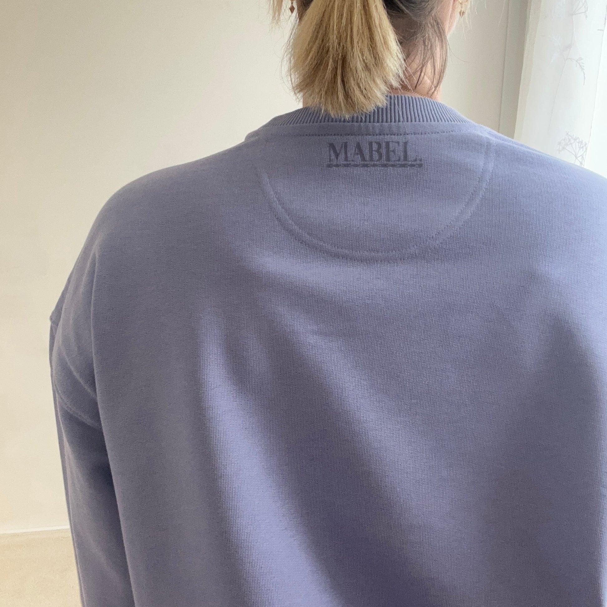 This is mabel oversized sweater back view with mabel logo