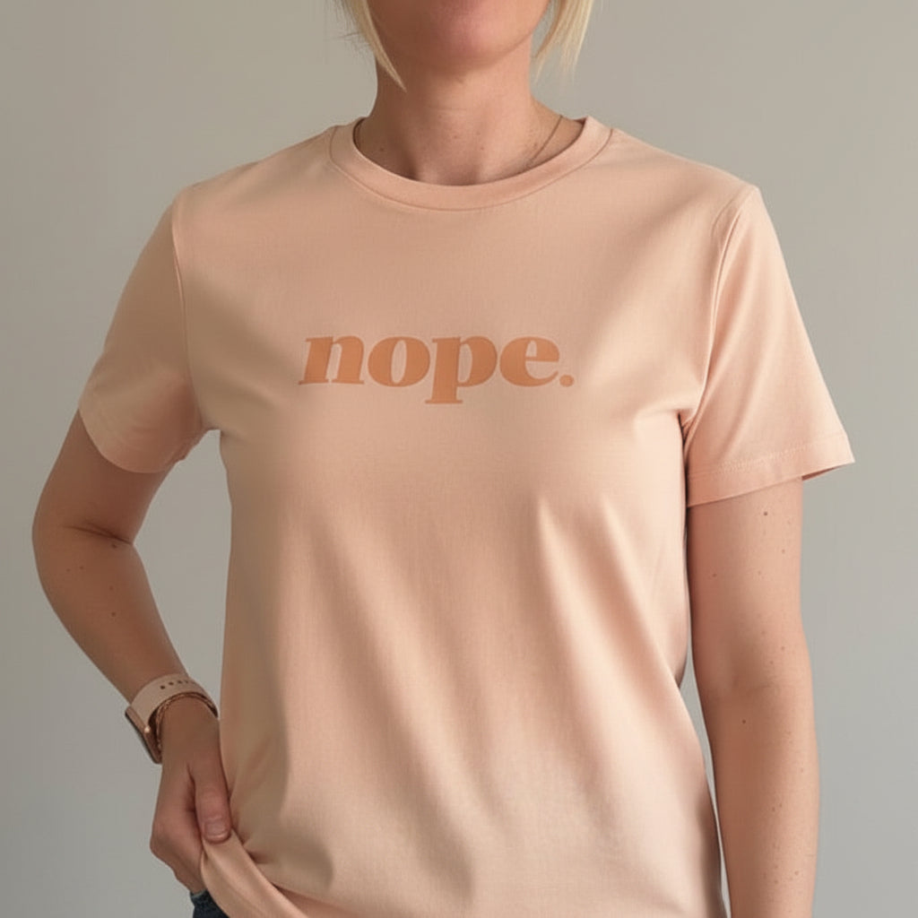 Person wearing a peach t-shirt with 'nope.' printed on it, this is mabel collection 