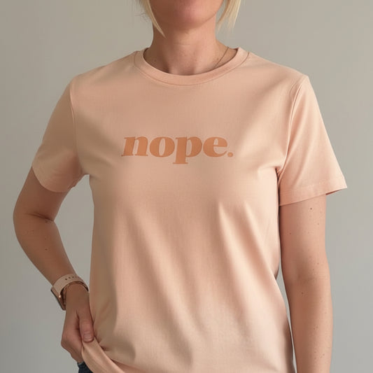 Person wearing a peach t-shirt with 'nope.' printed on it, this is mabel collection 