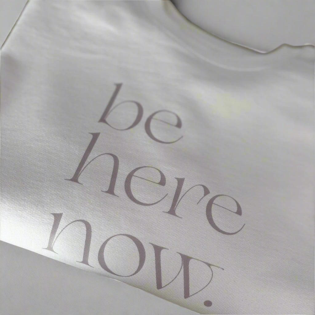 Cream oversized sweater with 'be here now' text, this is mabel collection