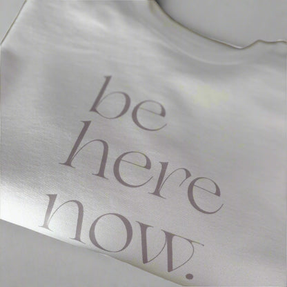 Cream oversized sweater with 'be here now' text, this is mabel collection