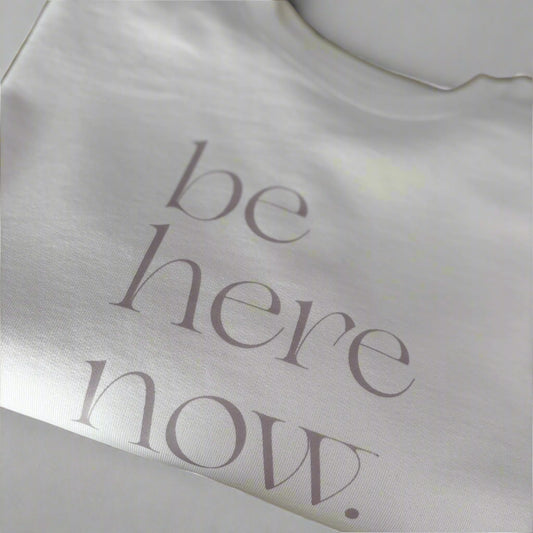 Cream oversized sweater with 'be here now' text, this is mabel collection